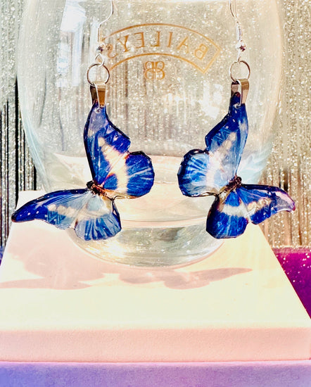Blue butterfly earrings made from resin by Flutterframes life like